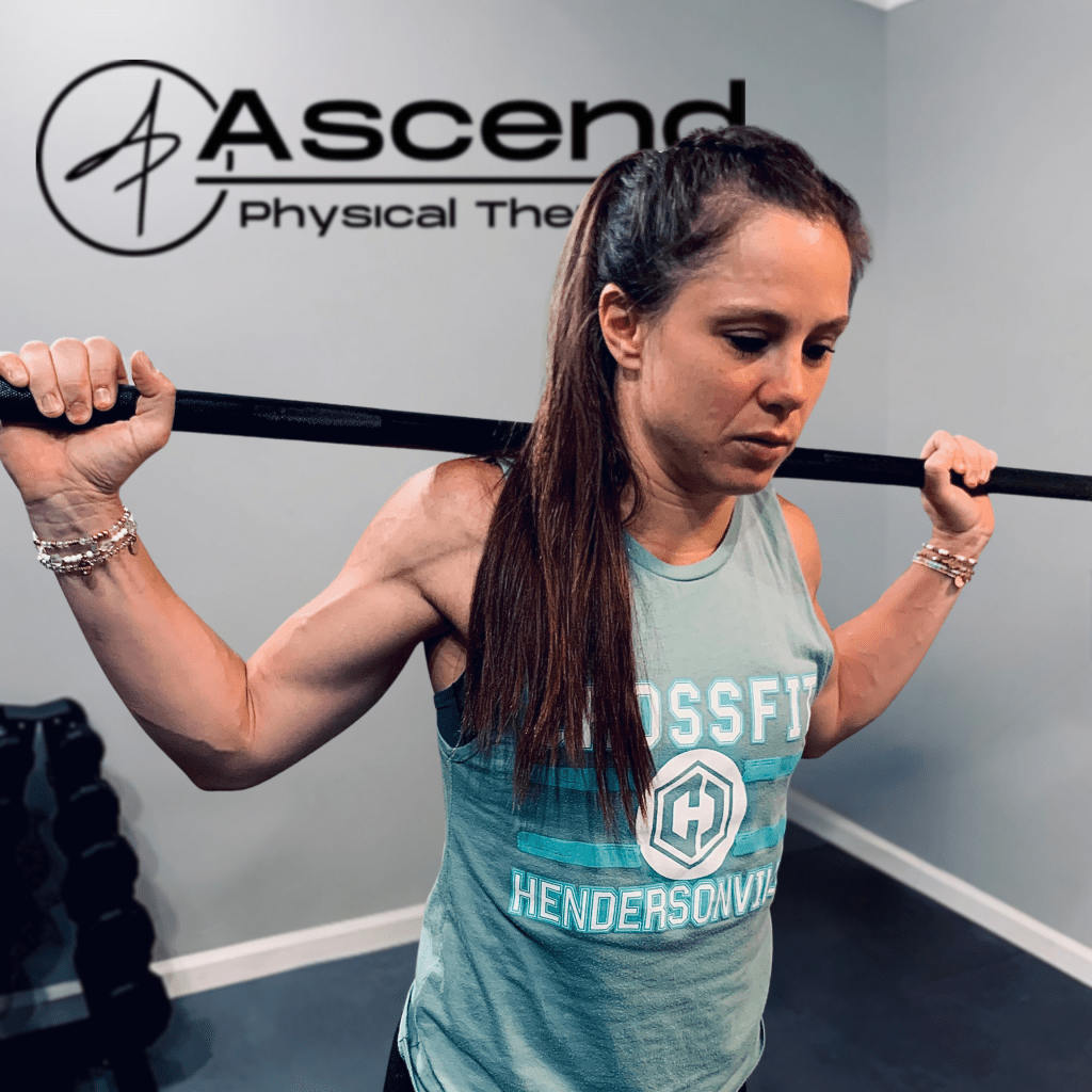 Woman lifting a barbell at Ascend Physical Therapy in Hendersonville, representing performance therapy in action.